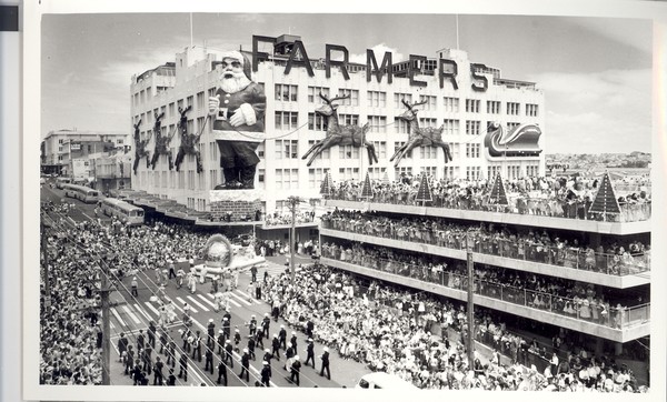 Crowds of onlookers watching the Santa Parade pass in front of the 79 foot giant Santa